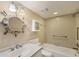 Bathroom with ship-wheel mirror, cabinet and shower-tub combo, exuding a nautical charm at 454 Cerromar Rd # 174, Venice, FL 34293