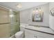 Bathroom featuring glass shower door, granite vanity top, and neutral colored finishes at 454 Cerromar Rd # 174, Venice, FL 34293