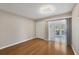 Bedroom features hardwood flooring and access to sunroom with bright natural light at 454 Cerromar Rd # 174, Venice, FL 34293