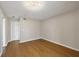 Spacious bedroom with wood floors, neutral walls, and a unique ceiling light fixture at 454 Cerromar Rd # 174, Venice, FL 34293