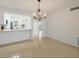 Cozy dining area open to kitchen with tiled flooring and chandelier at 454 Cerromar Rd # 174, Venice, FL 34293