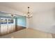 Bright dining room featuring tile floor, chair rail molding, and a decorative light fixture at 454 Cerromar Rd # 174, Venice, FL 34293