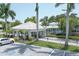Elegant community entrance with a covered drop-off area and well-manicured landscaping at 454 Cerromar Rd # 174, Venice, FL 34293