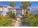 A beautiful two-story condo with a charming walkway and mature tropical landscaping at 454 Cerromar Rd # 174, Venice, FL 34293