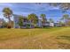 Low angle exterior view of a blue multi-Gathering building with landscaping and a green lawn at 454 Cerromar Rd # 174, Venice, FL 34293