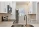 A well-equipped kitchen featuring modern stainless steel appliances and white cabinetry at 454 Cerromar Rd # 174, Venice, FL 34293
