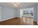 Comfortable living area with wood floors, blue walls, and natural light from the adjacent sunroom at 454 Cerromar Rd # 174, Venice, FL 34293