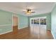 Open living room with hardwood floors, ceiling fan, and a view of the bright adjoining room at 454 Cerromar Rd # 174, Venice, FL 34293