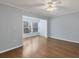 Living room showcasing light blue walls, ceiling fan, and hardwood flooring at 454 Cerromar Rd # 174, Venice, FL 34293