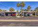 Community parking area with covered parking spots and well-maintained landscaping at 454 Cerromar Rd # 174, Venice, FL 34293