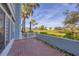 Picturesque patio area with a brick floor, offering serene views of the well-maintained green space at 454 Cerromar Rd # 174, Venice, FL 34293