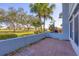 Outdoor brick patio perfect for relaxing with a view of the lush green lawn and mature trees at 454 Cerromar Rd # 174, Venice, FL 34293