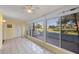 Bright sunroom features tile floors, fan, and large windows with views of the golf course at 454 Cerromar Rd # 174, Venice, FL 34293