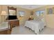 Bright bedroom with tile floors, large windows, and classic wooden furniture at 456 Matisse S Cir # 456, Nokomis, FL 34275