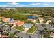 Stunning aerial view of a home with lush landscaping, a serene lake, and a golf course at 5106 Pine Shadow Ln, North Port, FL 34287