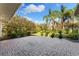 Beautifully landscaped backyard featuring a spacious brick patio at 5106 Pine Shadow Ln, North Port, FL 34287