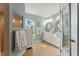 Stylish bathroom with double sink vanity, decorative mirrors and walk-in shower at 5106 Pine Shadow Ln, North Port, FL 34287