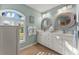 Bathroom with double sink vanity and decorative mirrors at 5106 Pine Shadow Ln, North Port, FL 34287