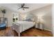 Well-lit bedroom featuring wood floors, neutral tones, and modern decor at 5106 Pine Shadow Ln, North Port, FL 34287