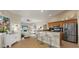 Open kitchen with breakfast bar seating overlooking the living room area at 5106 Pine Shadow Ln, North Port, FL 34287