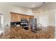 Kitchen with granite countertops, stainless steel appliances, and a sink overlooking a side yard at 5106 Pine Shadow Ln, North Port, FL 34287