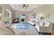 Bright living room with a fireplace, tray ceiling, neutral color palette, and tile flooring at 5106 Pine Shadow Ln, North Port, FL 34287