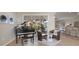 Spacious living room with piano and access to the lanai at 5106 Pine Shadow Ln, North Port, FL 34287