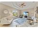 Bright living room with large window, tray ceiling, neutral color palette, and tile flooring at 5106 Pine Shadow Ln, North Port, FL 34287