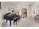 Living room featuring a piano, lanai access, and open floor plan at 5106 Pine Shadow Ln, North Port, FL 34287