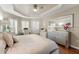 Comfortable main bedroom featuring a large mirror, a decorative ceiling, and wood floors at 5106 Pine Shadow Ln, North Port, FL 34287