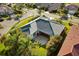 Aerial view of a well-maintained home showing the backyard patio and landscaping with nearby homes at 5106 Pine Shadow Ln, North Port, FL 34287