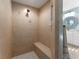 Tiled walk-in shower with built-in seat at 5106 Pine Shadow Ln, North Port, FL 34287