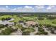 Lovely aerial view of a golf course and clubhouse with a scenic water feature at 5109 Pine Shadow Ln, North Port, FL 34287
