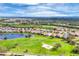 Aerial view of the community featuring homes surrounding a golf course and a scenic lake at 5109 Pine Shadow Ln, North Port, FL 34287