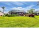 A spacious backyard featuring a screened-in patio, well-manicured lawn, and lush landscaping at 5109 Pine Shadow Ln, North Port, FL 34287