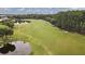 Picturesque golf course with ponds and manicured green fairways winding through a beautiful landscape at 5109 Pine Shadow Ln, North Port, FL 34287