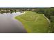 Scenic golf course view with a tranquil lake, lush green fairway, and strategically placed sand bunkers for a challenging game at 5109 Pine Shadow Ln, North Port, FL 34287