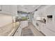 Modern kitchen with a view of the backyard, complete with granite countertops and white cabinets at 5109 Pine Shadow Ln, North Port, FL 34287