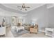Bright living room with a ceiling fan, light wood floors, and French doors to the exterior at 5109 Pine Shadow Ln, North Port, FL 34287