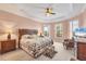 Spacious main bedroom with tray ceilings, a ceiling fan, and natural light at 5109 Pine Shadow Ln, North Port, FL 34287