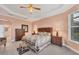 Relaxing main bedroom featuring tray ceiling, and a large window providing ample light at 5109 Pine Shadow Ln, North Port, FL 34287