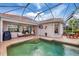 A view of the pool and patio with an outdoor seating area and a glimpse of the home's interior at 5109 Pine Shadow Ln, North Port, FL 34287