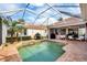 Screened-in pool and patio area offering a relaxing outdoor space with a view of the home's exterior at 5109 Pine Shadow Ln, North Port, FL 34287