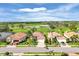 Neighborhood street featuring well-maintained homes, manicured lawns, and a scenic golf course backdrop at 5109 Pine Shadow Ln, North Port, FL 34287