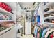Organized walk-in closet with shelving, hanging rods, and drawers to maximize storage potential at 5109 Pine Shadow Ln, North Port, FL 34287