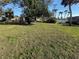 Expansive backyard with lush lawn and mature trees, providing shade and privacy for outdoor enjoyment at 519 Bellaire Dr, Venice, FL 34293