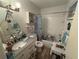 Bathroom featuring a shower-tub combo, a pedestal sink and great lighting at 519 Bellaire Dr, Venice, FL 34293