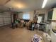Spacious garage featuring roll up door, overhead lighting and ample room for storage and two cars at 519 Bellaire Dr, Venice, FL 34293