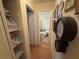 Hallway view to bathroom with built in shelves, and laminate flooring at 519 Bellaire Dr, Venice, FL 34293