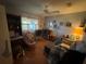Inviting living room with a ceiling fan, laminate wood flooring, and comfortable seating arrangement at 519 Bellaire Dr, Venice, FL 34293